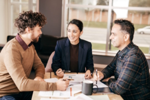 Three people meeting at comically small table