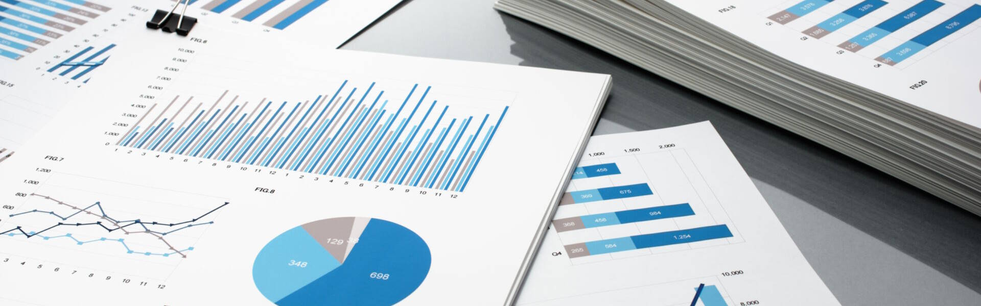 Investment documents on desk charts and graphs
